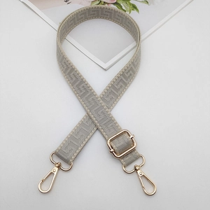 Adjustable geometric pattern bag strap with gold metal hooks and gray white weaving