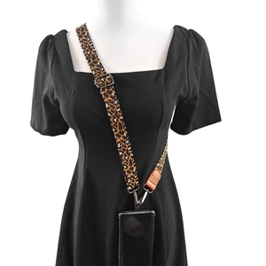 Detail of leopard print crossbody phone strap with brown leather and metal hook