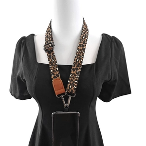 Detail of leopard print phone lanyard with metal hook and leather reinforced strap
