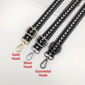 Adjustable black and white arrow pattern nylon strap with gold, silver and gunmetal hooks