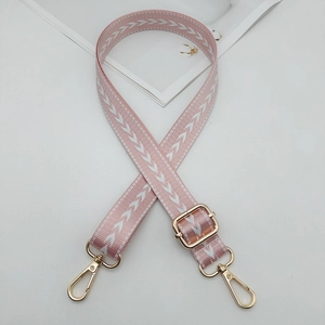 Close-up of pink and white arrow pattern nylon strap with golden swivel hooks
