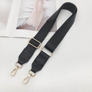 Adjustable black faux leather shoulder strap with gold metal hooks on white background