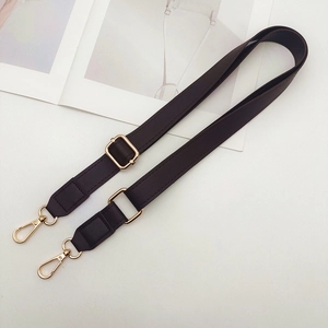 Detail of adjustable PU leather bag strap in dark coffee with gold metal buckles