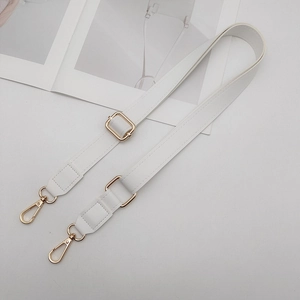 Close-up of white PU leather bag strap featuring gold swivel metal hooks and adjustable buckle