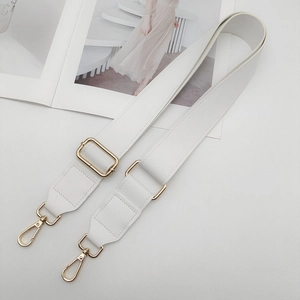 Close-up of adjustable white PU leather bag strap with gold metal buckle and lobster clasp
