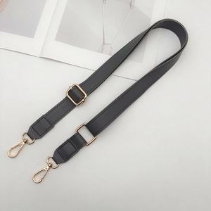 Close-up of dark grey PU leather adjustable bag strap with gold metal hooks and pebble texture