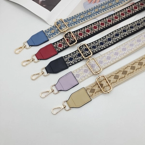 Detailed view of ethnic jacquard wide bag straps with vintage patterns and gold hooks