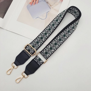 Detail view of adjustable geometric diamond pattern bag strap with gold metal hardware