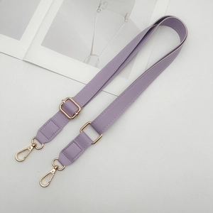 Macro shot of light purple adjustable PU leather strap with golden metal lobster clasps