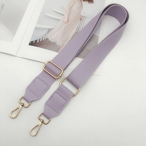 Detail of adjustable lilac PU leather strap with golden lobster clasps for handbags