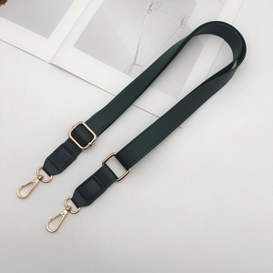 Detail of adjustable dark green PU leather shoulder strap with gold metal swivel hooks