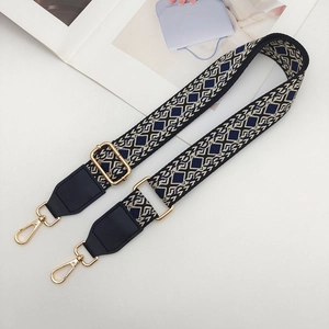 Detail of adjustable geometric weave strap with black leather ends and gold lobster claws
