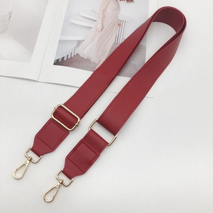 Close-up of burgundy PU leather crossbody strap with adjustable gold buckle and metal hooks