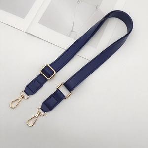Detail view of navy blue PU leather adjustable purse strap with gold lobster clasps