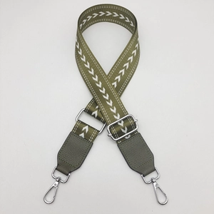 Adjustable green woven strap for small tote bag with white arrow patterns and silver hooks