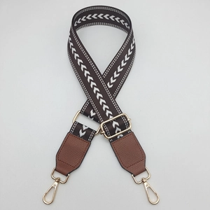 Close-up of bohemian style canvas bag strap with geometric patterns and leather ends