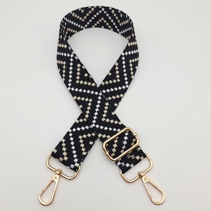 Close-up of bohemian chevron pattern woven strap with premium gold metal hardware
