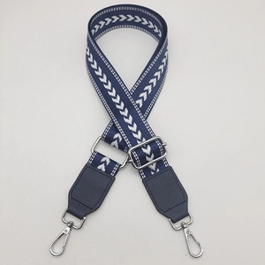 Adjustable navy canvas strap with arrow pattern and silver hooks for crossbody bags