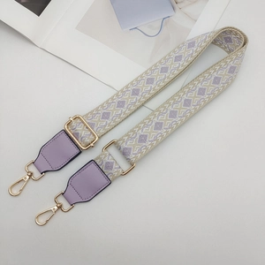 Detail of adjustable ethnic style wide strap with purple leather and gold metal hooks