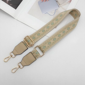 Detail of adjustable geometric jacquard strap with gold metal hooks and leather ends