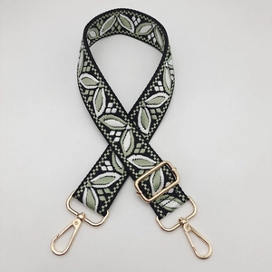 Detail showing wide adjustable guitar style shoulder strap with green leaf jacquard pattern
