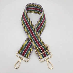 Close-up of ethnic colorful striped wide strap with polished light gold lobster clasps