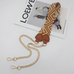 Close-up of geometric pattern strap with gold chain and leather connectors for handbags