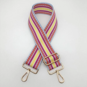 Close-up of colorful ethnic style wide guitar strap with golden metal swivel hooks