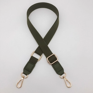 Detail of army green nylon shoulder strap with gold lobster clasps and adjustable buckle