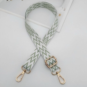Adjustable green and white embroidered geometric pattern strap with gold metal hardware