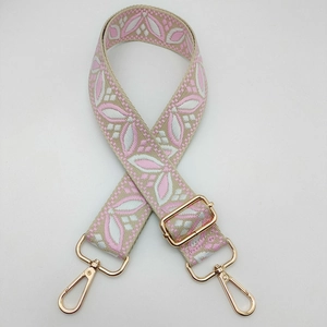 Detail of adjustable floral embroidery strap with premium gold metal lobster clasps
