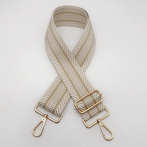 Detail of 5cm ethnic style wide woven bag strap with golden metal lobster hooks