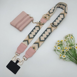 Ethnic style woven phone strap with pink mini pouch and gold lobster clasp detail