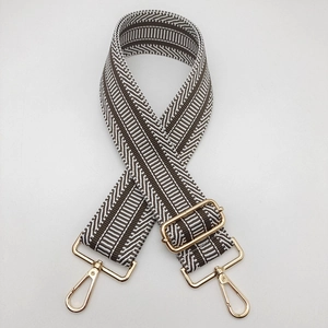 Detail of adjustable 5cm ethnic style wide strap with gold metal hooks for handbags