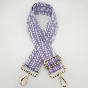 Detail of 5cm purple and white geometric woven strap with gold metal hooks and buckles