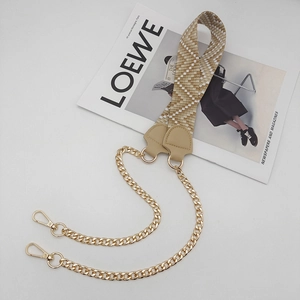 Detail of beige jacquard woven strap with light gold metal chain and lobster clasp