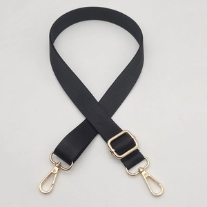 Macro detail of black nylon replacement strap with golden metal swivel lobster clasps