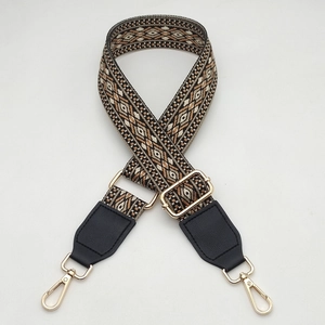 Close-up of ethnic woven strap with geometric patterns and golden metal clasps