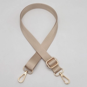Detail of adjustable beige woven strap with chevron pattern and gold metal lobster clasps
