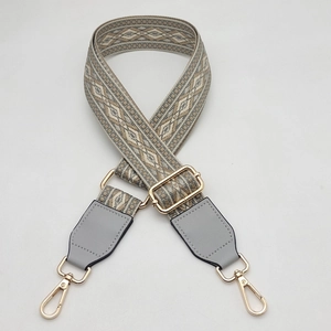 Close-up of adjustable woven shoulder strap with geometric patterns and leather details