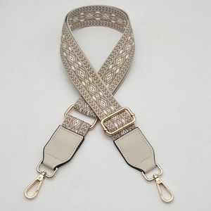 Adjustable geometric woven bag strap with leather ends and gold metal lobster hooks