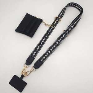 Detail of adjustable geometric strap with leather coin purse and gold metal hardware