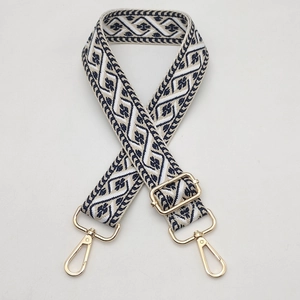 Close-up of bohemian navy and cream jacquard bag strap with gold metal swiveling clasps