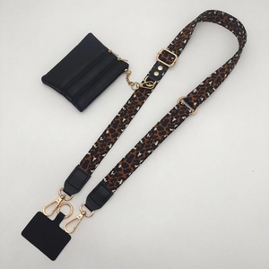 Detail of leopard print strap with black leather coin pouch and gold hardware hooks