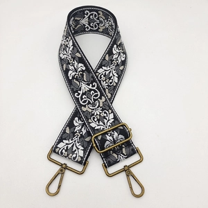 Ethnic embroidery strap with black and white floral pattern and bronze metal hooks