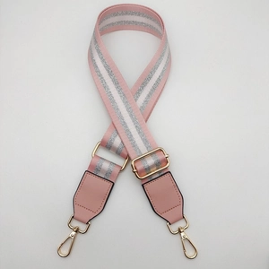 Detailed view of adjustable pink and silver glitter striped strap with golden hardware