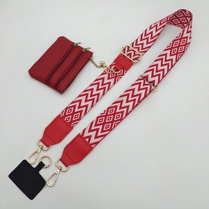 Detail view of red geometric woven strap with mini zipper pouch and gold metal hardware