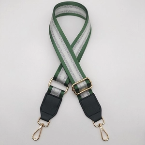 Detail of forest green replacement shoulder strap with silver stripes and gold metal hooks