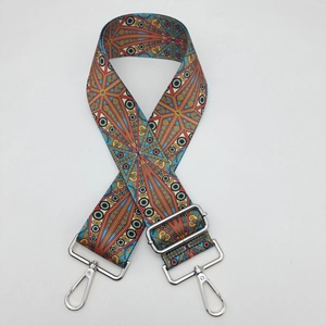 Detailed texture of bohemian wide bag strap with colorful geometric mandala pattern