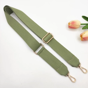 Detail of 3.8cm wide olive green canvas bag strap with golden metal lobster clasps